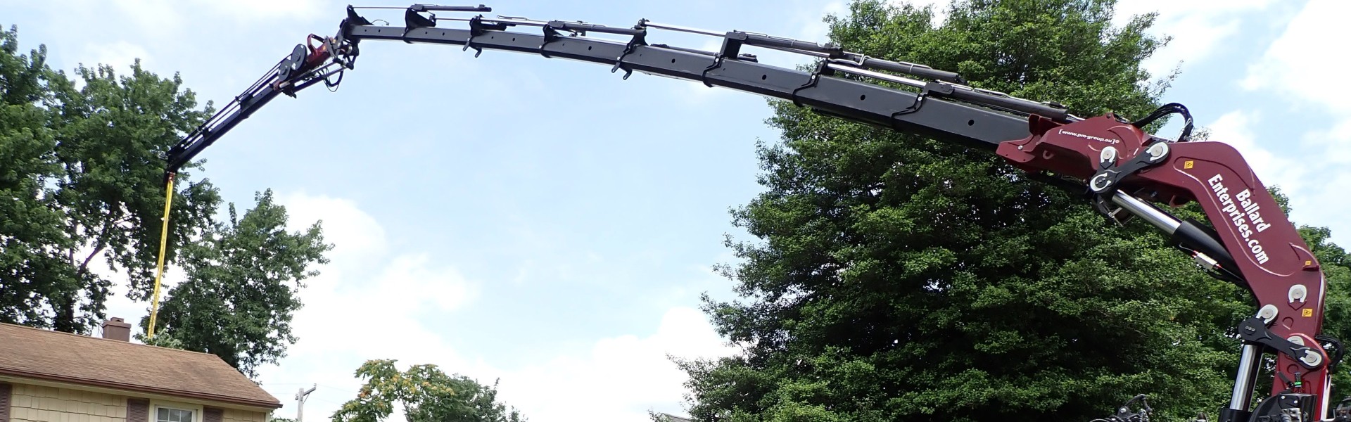 Grapple saw crane removing a tree with precision and zero ground impact in Maryland.
