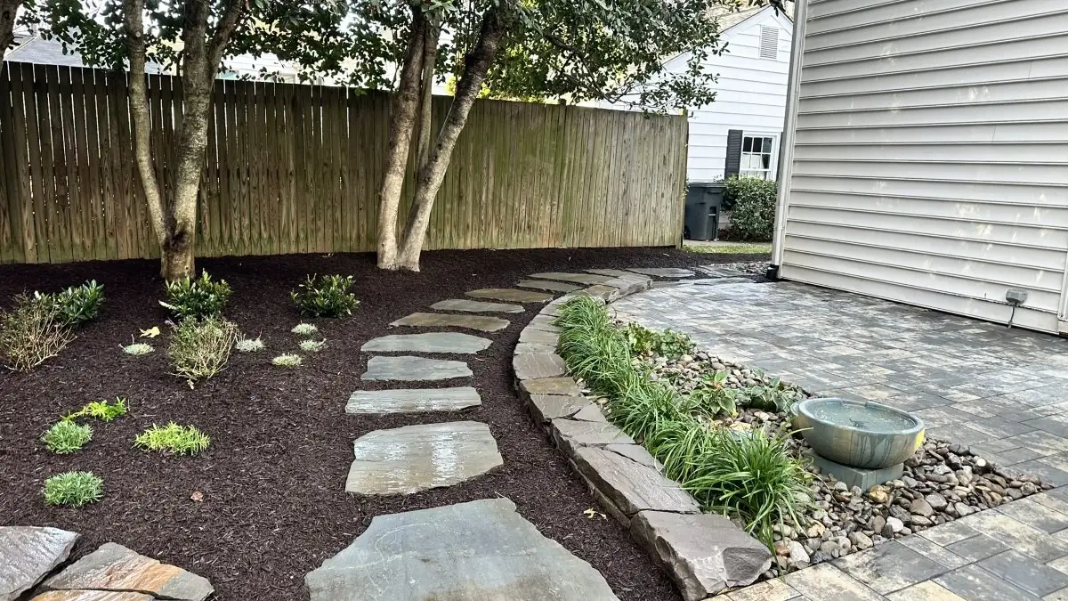 A professionally maintained Central Maryland property with fresh mulch, well-drained planting beds, and shrubs prepared for fall.